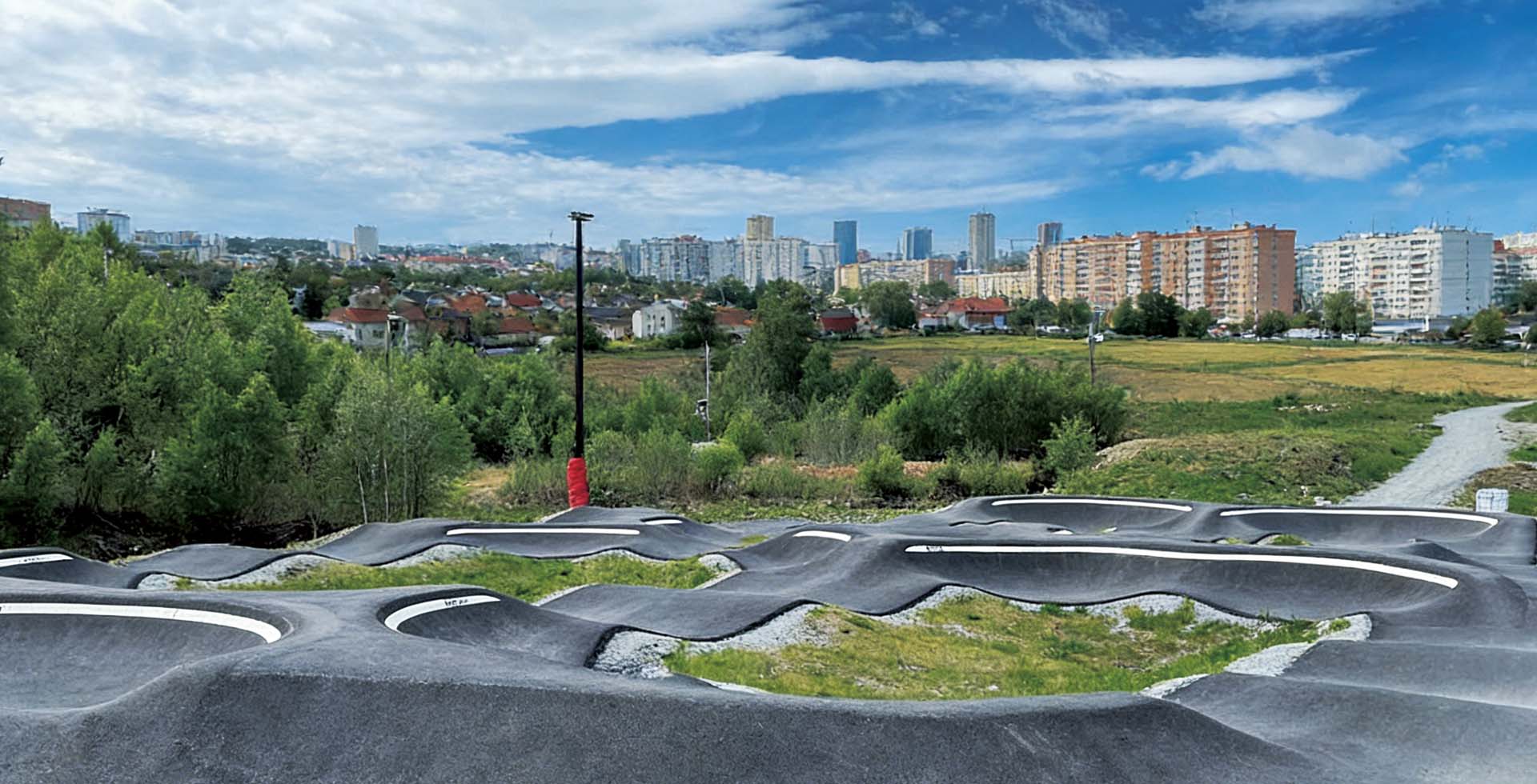 A pump track forms a closed loop of wavy ground