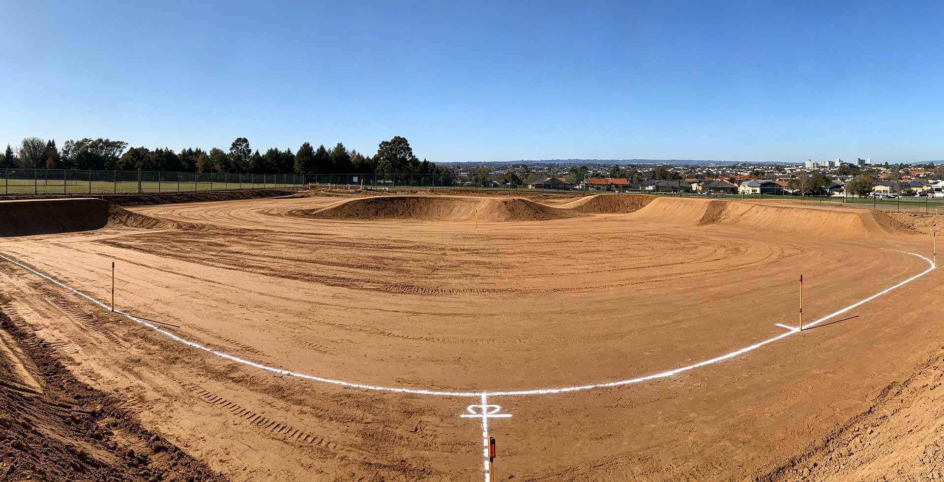 Prepared site with marked boundaries for modular pump track installation